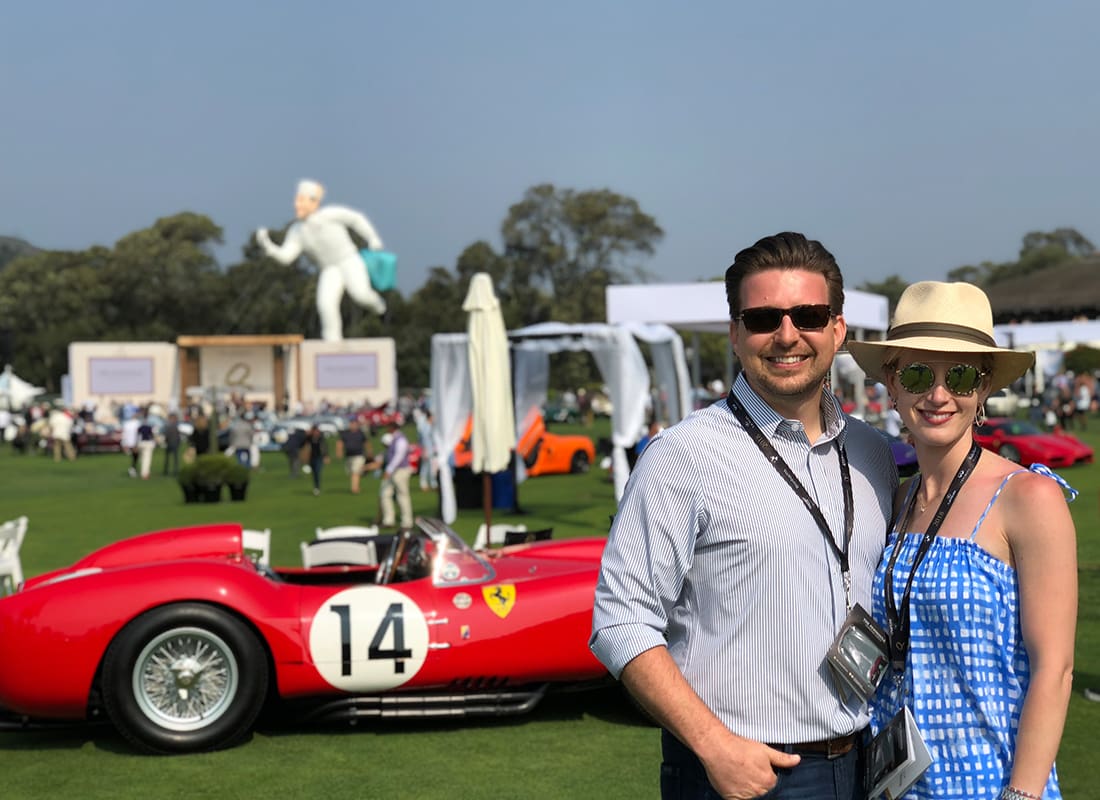 Insurance Solutions - Adam and Anne Standing in Front of a Quail at a Car Outdoor Car Event